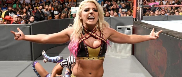 Alexa Bliss taunting the crowd while an injured Sasha Banks is attended to by a referee