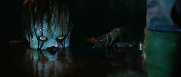 Pennywise surfacing from the water in the flooded basement