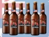 Six bottles of beer labelled with Miscast and Watchman logos in front of the Australian Flag