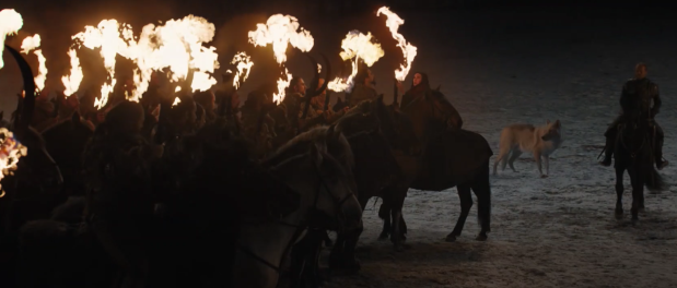 The Dothraki in formation on horseback with flaming weapons